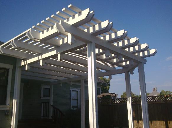 Backyard home remodel side view of patio cover (rafter tails match house)